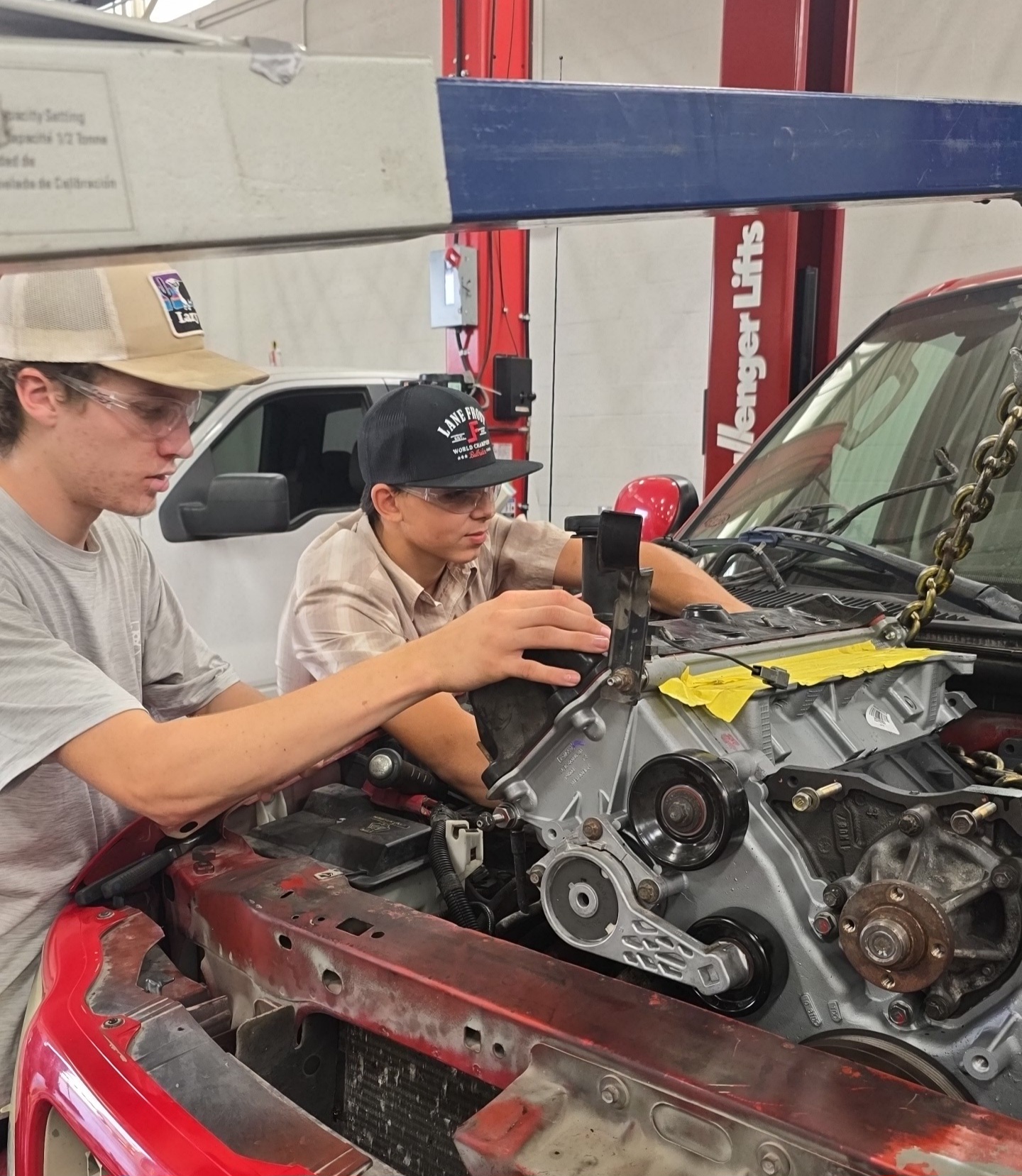 students working on a car